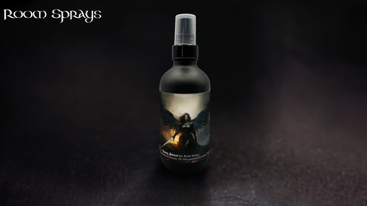 Black room spray bottle with spray cap featuring The Morrigan’s Shadow winged warrior label, displayed on a dark cloth surface.